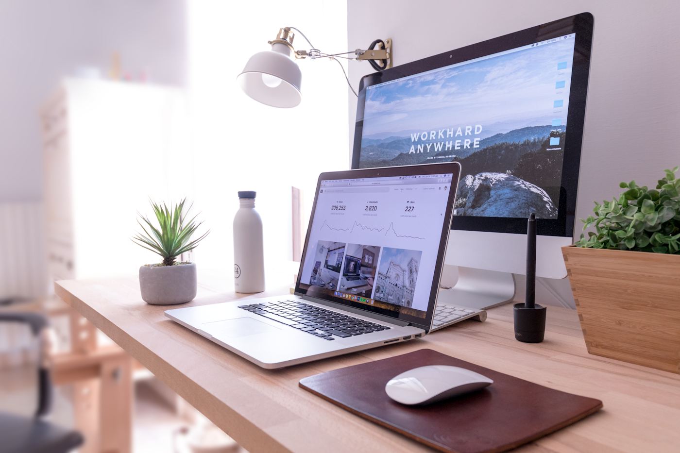 Bright desk with a laptop and notebook